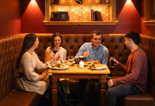 Bar seating area 2 people eating and chatting 1 - Sligo Southern Hotel